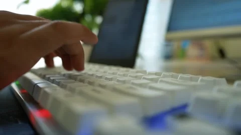 Hands Typing on White Keyboard, Close-up of hands typing on a white keyboar.. Stock Footage 317737165