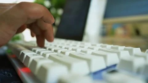 Hands Typing on White Keyboard, Close-up of hands typing on a white keyboar.. Stock Footage 317737169