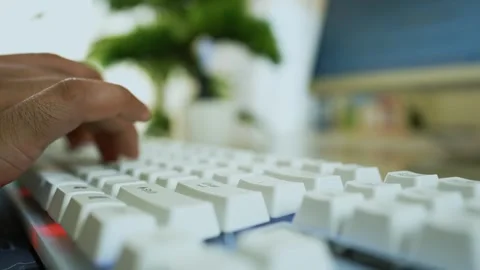 Hands Typing on White Keyboard, Close-up of hands typing on a white keyboar.. Stock Footage 317737193