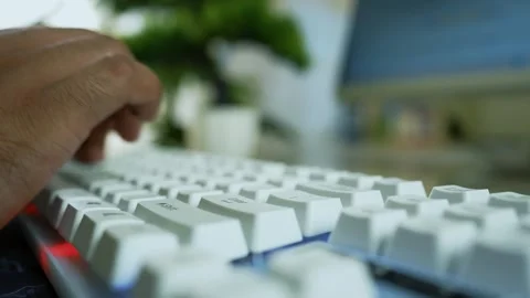 Hands Typing on White Keyboard, Close-up of hands typing on a white keyboar.. Stock Footage 317737203