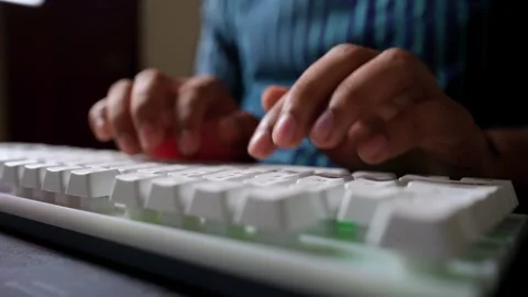 Hands Typing on White Keyboard, Close-up of hands typing on a white keyboard Stock Footage 317737415