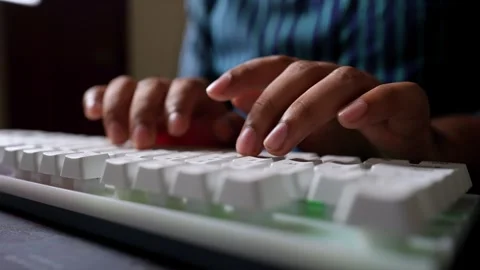 Hands Typing on White Keyboard, Close-up of hands typing on a white keyboard Stock Footage 317737418