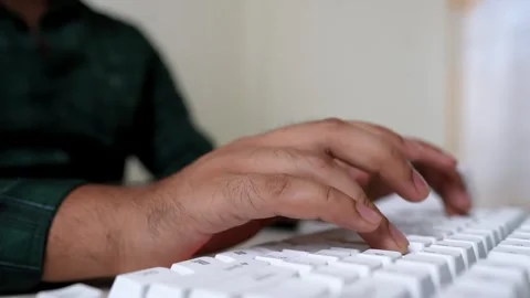 Hands Typing on White Keyboard, Close-up of hands typing on a white keyboar.. Stock Footage 318056594