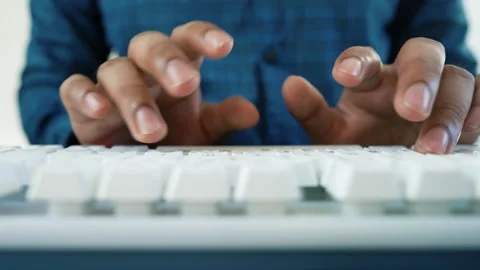 Hands Typing on White Keyboard, Close-up of hands typing on a white keyboar.. Stock Footage 318057151