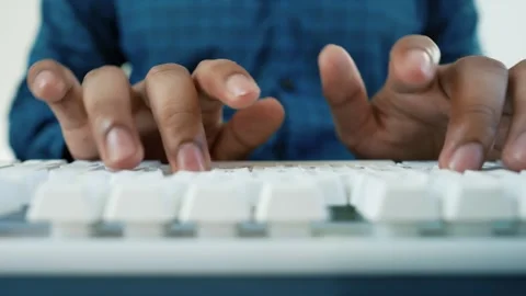 Hands Typing on White Keyboard, Close-up of hands typing on a white keyboar.. Stock Footage 318057159