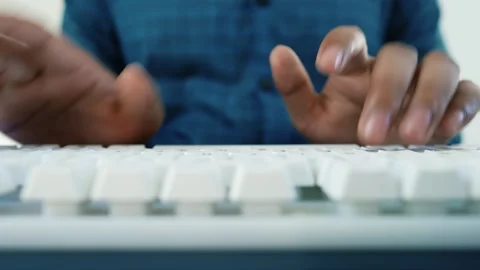 Hands Typing on White Keyboard, Close-up of hands typing on a white keyboar.. Stock Footage 318578240