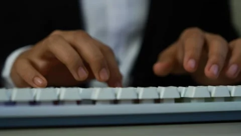 Hands typing on white keyboard, Close-up of hands typing on a white keyboar.. Видео 329177196