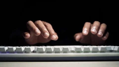 Hands typing on white keyboard in dark low light, Close-up of hands typing .. Stock Footage 334285709