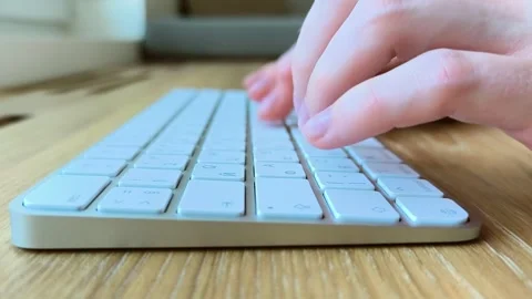 Hands typing on a white keyboard from the side. Fingers pressing keys on a .. Stock Footage 342540760