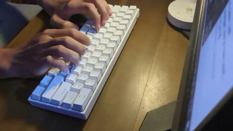 Hands typing on a white mechanical computer keyboard Stock Footage 338146031