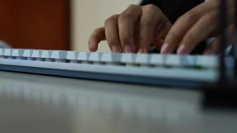Hands typing on white mechanical keyboard, Close-up of hands typing on a wh.. Видео 329177320