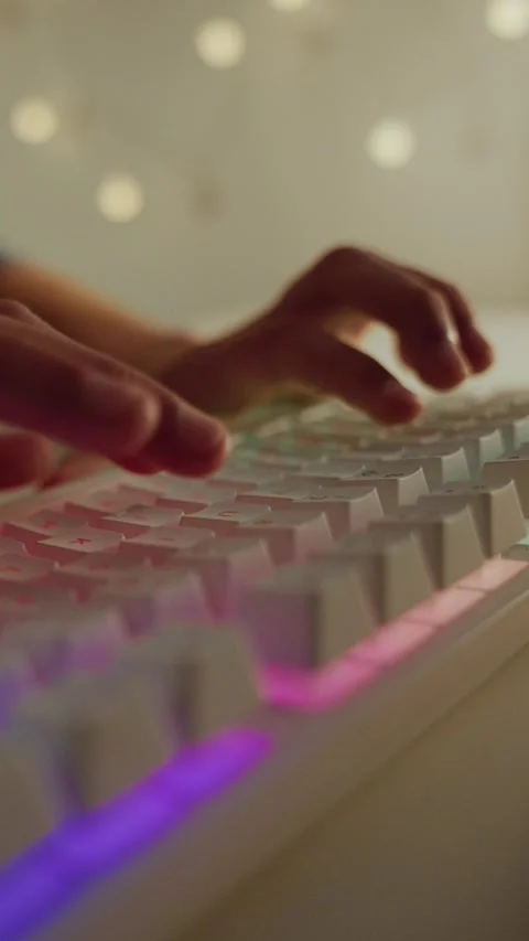 Hands Typing on a White Mechanical Keyboard with RGB Backlight Stock Footage 336316768