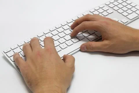 Hands typing on the white wireless keyboard Stock Photos