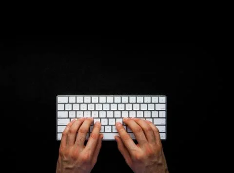 Hands typing on wireless keyboard on black leather desk with copy space 写真素材