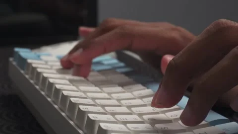 Hands typing on wireless keyboard on desk Stock Footage 276636411