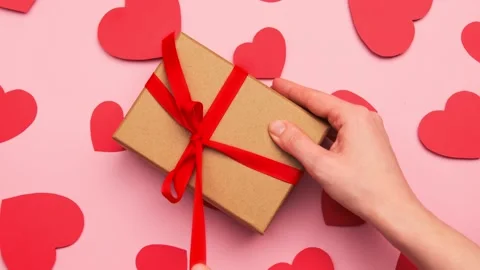 Hands unboxing opening empty craft gift box with bow for valentine's day Stock Footage 146133101