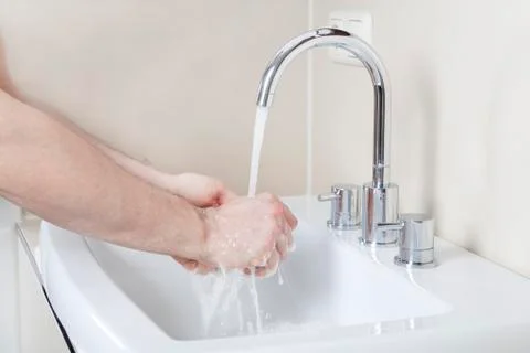 Hands under the tap Stock Photos