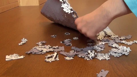 Hands undo puzzle separating small pieces Stock Footage 82310367
