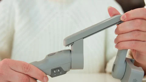 Hands unfolding portable device hinge with controlled rotation, widening gap 動画素材 347615514