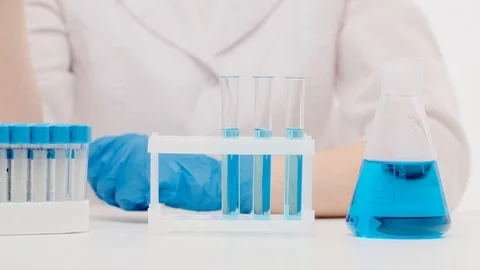 Hands of an unidentified female lab worker pick up test samples Stock Footage 128234629