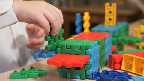 Hands of unknown child playing with building kit Stock Footage 87848836