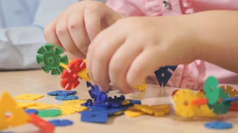Hands of unknown child playing with building kit Stock Footage 89229440