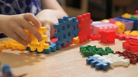 Hands of unknown child playing with building kit Stock-Footage 90917861