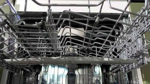 Hands unload the dishwasher removing mugs from the upper rack viewed from b.. Stock Footage 338397739
