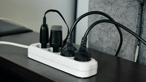 Hands unplug many adaptor from electrical outlet and turn off electricity switch Stock Footage 132582790