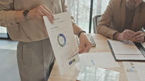 Hands of Unrecognizable Female Analyst Presenting Sales Data at Team Meeting Stock Footage 244945981