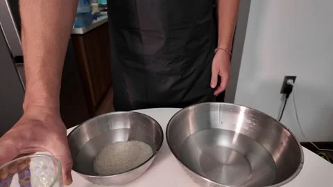 The hands of an unrecognizable man washing raw rice in a bowl Stock Footage 330055221