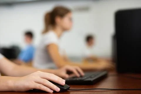 Hands of unrecognizable pupil using computer in classroom 스톡 사진