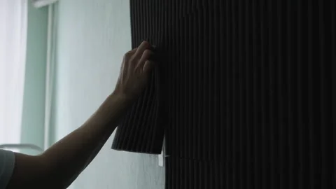 Hands of unrecognizable woman applying dark soundproofing panel to light green Stock-Footage 342771210