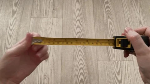 Hands Unrolling Tape Measure Close Up Demonstration Stock Footage 324453092