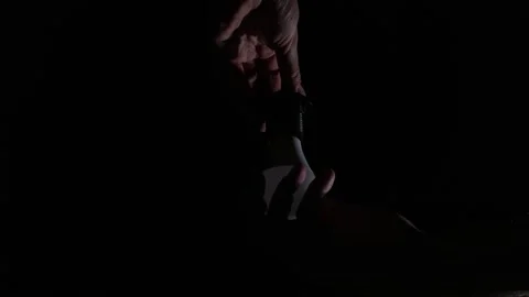 Hands Unscrew a Flickering Led Light Bulb from a Hanging Socket in the Dark Stock Footage 334134616