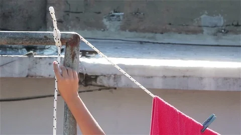 Hands Untangling Clothesline Rope in Modest Home, Daily Chore, Close Up  Stock Footage 84209246