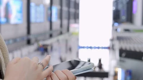 Hands use mobile phone in modern transit hub Stock Footage 340938632