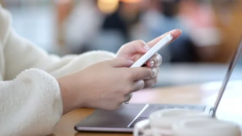 Hands use phone, laptop on table Video stock 345705461