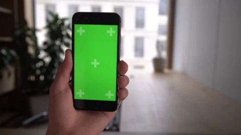 Hands use touch holding a mobile telephone with a vertical green screen in tram Stock Footage 129117847