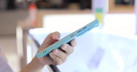 Hands using and holding a smartphone in an mobile phone store, Technology Stock Footage 338192210