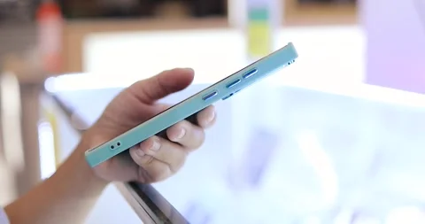 Hands using and holding a smartphone in an mobile phone store, Technology, .. Stock Footage 339385610