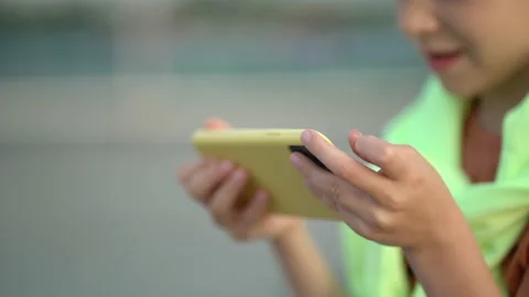 Hands using app on mobile phone over sunset. Close up young attractive boy using Vídeos de archivo 202571569