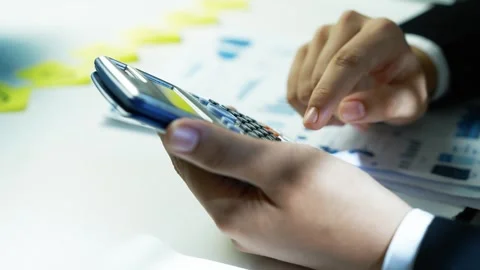 Hands Using Calculator on Desk with Documents Stock Footage 321223637