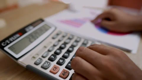 Hands Using Calculator with Financial Documents Stock Footage 315982429