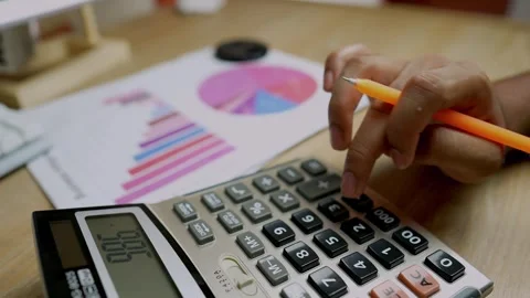 Hands Using Calculator with Financial Documents Stock Footage 315982443