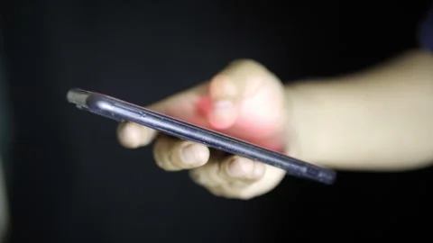 Hands using a cell phone at night, watching social networks Stock Footage 272255031