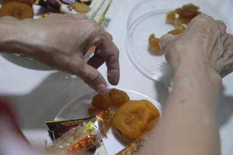 Hands using chopsticks to pick up pieces of street food Stock Photos
