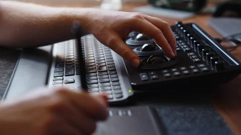 Hands Using Color Grading Control Panel and Keyboard in Modern Editing Workspace Stock Footage 345691524