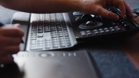 Hands Using Color Grading Control Panel and Keyboard in Modern Editing Studio Stock Footage 345692706