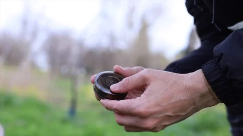 Hands using a compass in the field Stock Footage 128984596